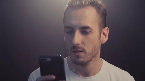 The guy communicates on the Internet via the phone Stock-Footage 80653723