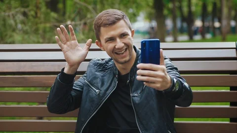 The guy communicates on video chat via smartphone Stock Footage 107834789