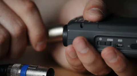 Guy connects cable to the audio recorder Video stock 48935829