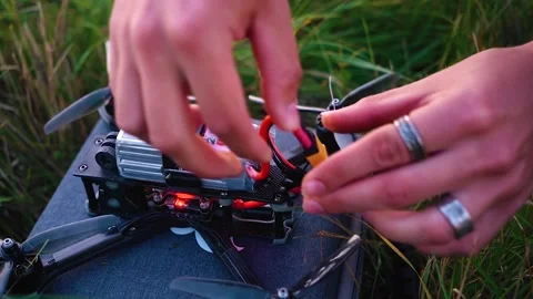 The guy connects the wires including the quadcopter battery. Shooting close-up Stock Footage 139490051