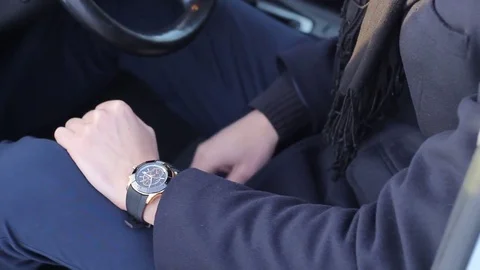 Guy is Considering Wrist Watch Stock Footage 70794349