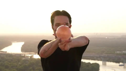 Guy-contact juggler shows his fantastic skills of balance and control of the Stock Footage 80093039