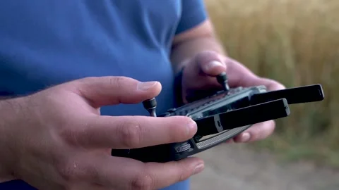 The guy controls the drones. remote control of the drone in hands. Stock Footage 157318906