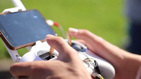 Guy controls a quadrocopter in summer. Stock Footage 130733775