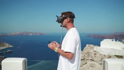 A guy controls a racing drone in virtual reality glasses Stock Footage 159587053