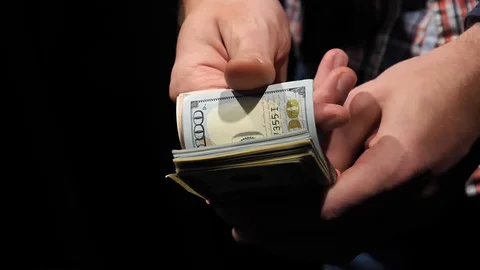 The guy counts dollars in slow motion with his fingers. Stock Footage 129786352