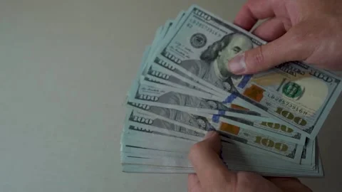 Guy counts stack of dollars, close hand plan, counting money, financial Stock Footage 220477227