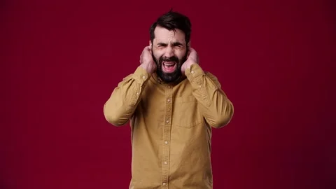 The guy covers his ears because he plays very loudly Stock Footage 165620445