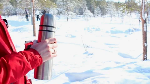 The guy covers the thermos outdoor Stock Footage 88374685