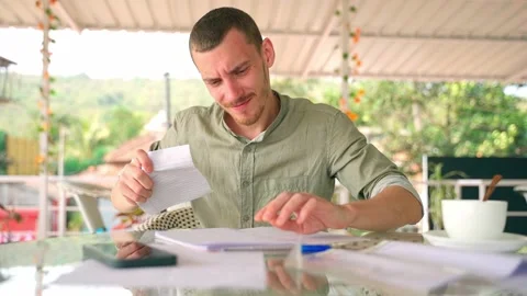 The guy crosses out the notes in his notebook and rips out the sheet. Video stock 231336902