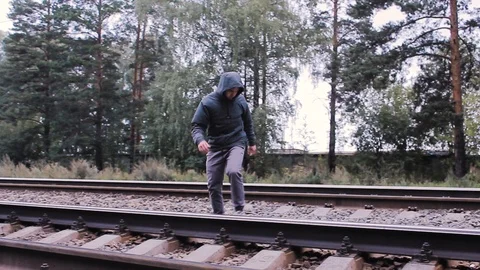 The guy crosses the railroad backwards Stock Footage 113859391