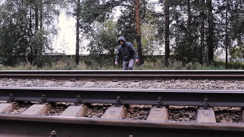The guy crosses the railroad Stock Footage 113859392