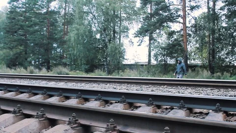 The guy crosses the railroad Stock Footage 113859414