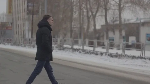 The guy crosses the road | 60 FPS Stock Footage 89875432