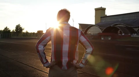 Guy is  crossing the stadium at the sunset against backlight Video stock 64813965