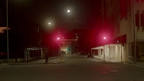 A guy crossing the street after work late at night Stock Footage 236439392