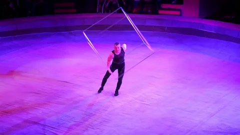 A guy with a cup in his hands performs cool tricks, arranges a show for the Stock Footage 168644446