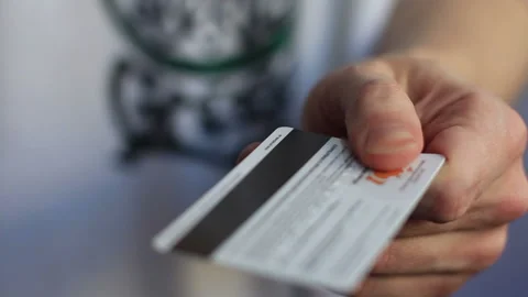 Guy cuts a credit card with scissors Stock Footage 120906738