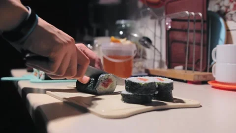The guy cuts the rolls. cooking at home Stock Footage 143476464