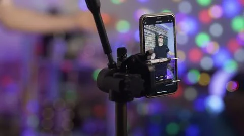 The guy dances on the phone camera and nothing works out for him. A view of the Stock Photos