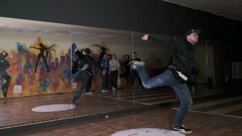 Guy dancing break dance in the hall with mirrors. Youth subculture. Slow motion Stock Footage 131879161