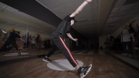 Guy dancing break dance in the hall with mirrors. Youth subculture. Slow motion Stock Footage 131879189