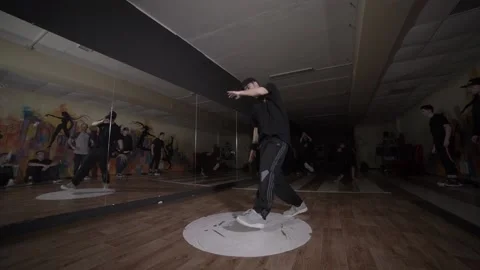 Guy dancing break dance in the hall with mirrors. Youth subculture. Slow motion Stock Footage 131879207
