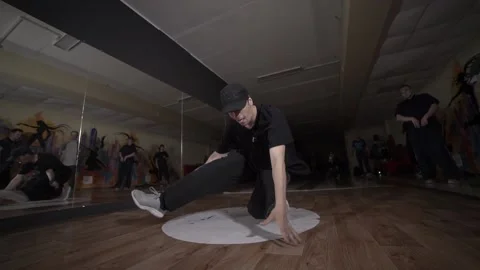 Guy dancing break dance in the hall with mirrors. Youth subculture. Slow motion Stock Footage 131879239