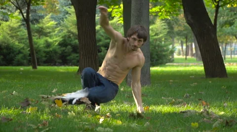 The guy is dancing on the grass Stock Footage 68414806