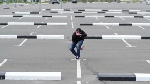 Guy dancing hip hop in the car parking. Contemporary choreography. Slow motion Stock Footage 138808323