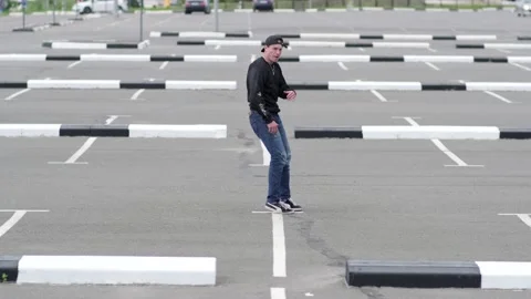 Guy dancing hip hop in the car parking. Contemporary choreography. Slow motion Stock Footage 138808342