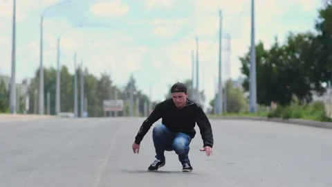 Guy dancing hip hop on the road. Contemporary choreography. Slow motion Stock Footage 138808576