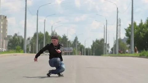 Guy dancing hip hop on the road. Contemporary choreography. Slow motion Stock Footage 138808679