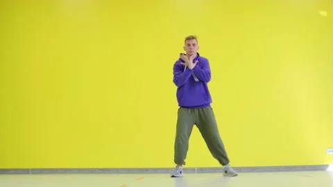 Guy dancing hip hop in the studio against a yellow wall. Isolated. Stock Footage 139756491