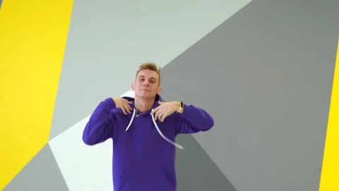 Guy dancing hip hop in the studio in front of the wall with geometric pattern Stock Footage 142820065