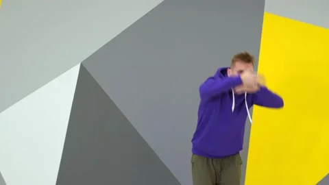 Guy dancing hip hop in the studio in front of the wall with geometric pattern Stock Footage 142820172
