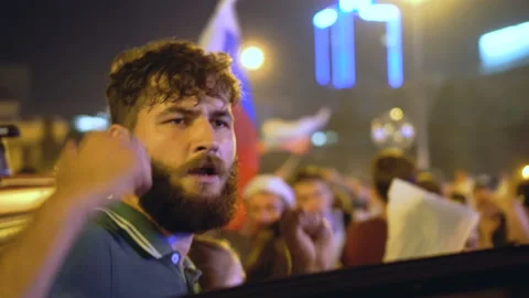 Guy dancing near car with crowd. Atmospheric celebration in honor of victory. Stock Footage 96481709