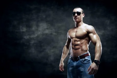 Guy on the dark background with sunglasses Stock Photos