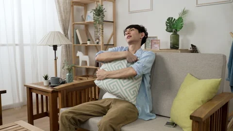 Guy defeated in mobile game is holding a cushion Video stock 162814144