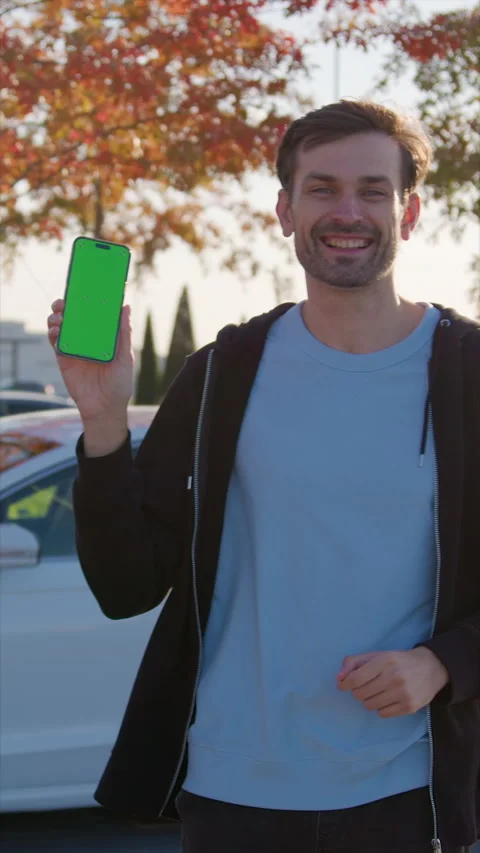 Guy demonstrates successfully completed car sharing order Stock Footage 300545204