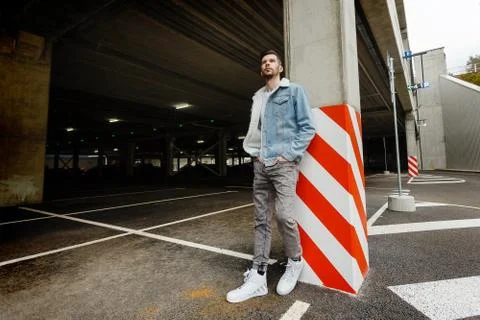 Guy in a denim jacket posing in the parking lot Stock Photos