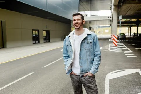 Guy in a denim jacket posing in the parking lot Stock Photos