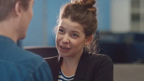 The guy in denim shirt telling funny story. Young cute girl laughing, closing Stock Footage 85628574