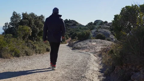 Guy descends a steep slope from a mountain, Spain Stock Footage 101270112
