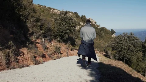 Guy descends a steep slope from a mountain Stock Footage 101270146