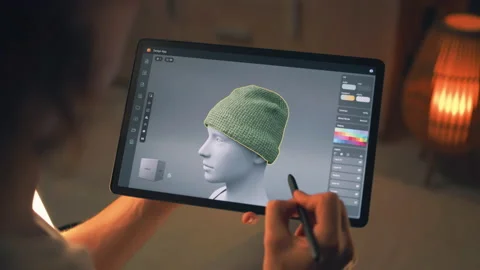 Guy designing clothes in app on tablet Stock Footage 211797688