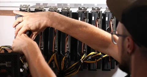 The guy disassembles his mining rig taking out the video card one by one Stock Footage 156040653
