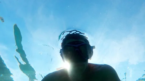 The guy dives under the water Stock Footage 196788909