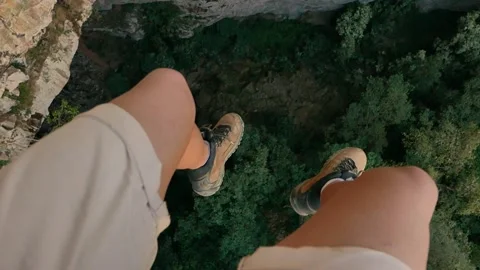 Guy do rappelling looking down Stock Footage 146101323