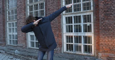Guy does a dance dab on a street in the city Stock Footage 88767524